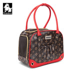 Sac de transport noir et marron avec motif, poignées rouges et poche latérale en maille