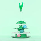 Tourniquet de jouet pour chat vert, plume sur tige et balle rose et bleue